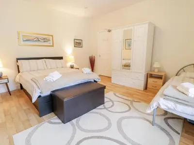 a bedroom with a bed and a dresser in it at Abermaw Views in Barmouth