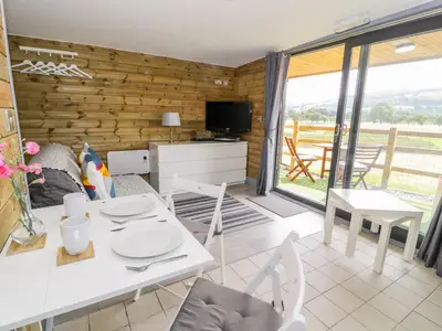 a living room with a white table and chairs at Cilan Lodge in Corwen