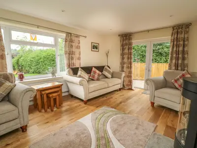 a living room with a couch and two chairs at New Peny in Llandrindod Wells