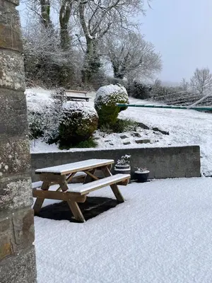 a wooden picnic table sitting in the snow at Ffyllon Fawr in Henfynyw Upper