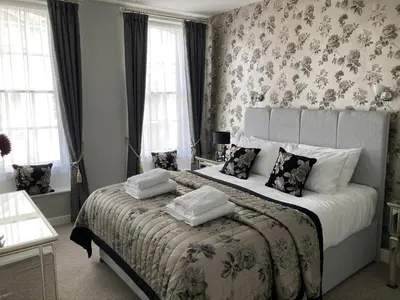 a bedroom with a bed with two pillows on it at Assembly View - two bedroomed apartment with parking permit in Ludlow Town Centre in Ludlow