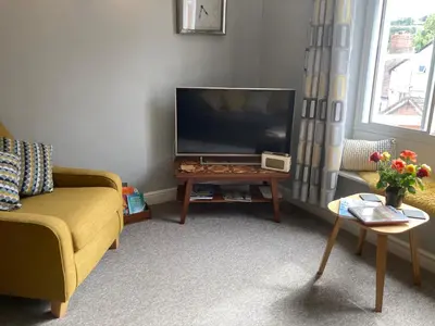 a living room with a large flat screen tv at Assembly View - two bedroomed apartment with parking permit in Ludlow Town Centre in Ludlow