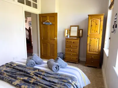 a bedroom with a bed with stuffed animals on it at Cliff haven in Borth