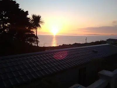 a sunset from the roof of a house at Hendre Coed Isaf static caravan Barmouth in Barmouth