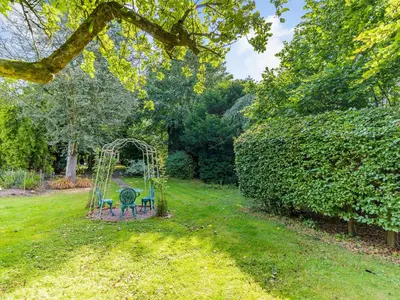 a garden with a swing set in the grass at Riverside in Craven Arms