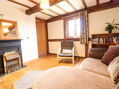 a living room with a couch and a fireplace at The Old House in Llanidloes