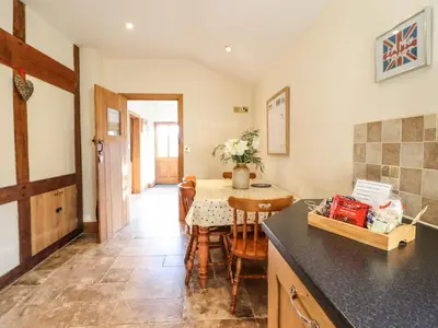 a kitchen and dining room with a table and chairs at The Old House in Llanidloes