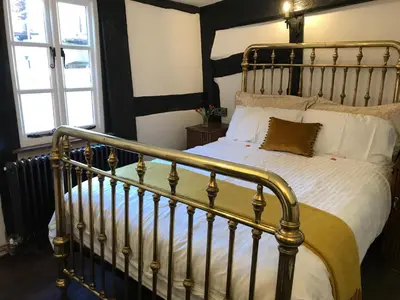 a bedroom with a metal bed with white pillows at 