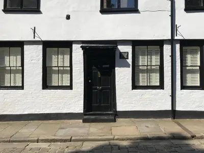 a white building with a black door and windows at 