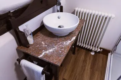 a bathroom with a white sink and a radiator at 