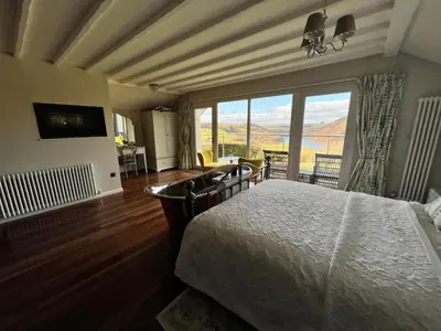 a bedroom with a bed and a large window at Ty Capel in Llanidloes
