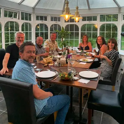 a group of people sitting around a table at Ty Capel in Llanidloes