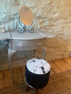 a desk with a chair and a mirror and a stool at Ty Capel in Llanidloes
