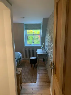 a room with a sink and a desk and a window at Ty Capel in Llanidloes