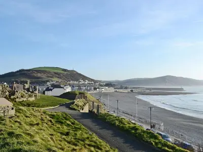 a view of a beach with houses and the ocean at Grosvenor House APT 3 in Aberystwyth