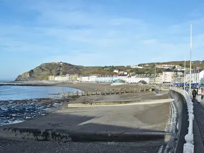 a view of a beach with buildings and the ocean at Grosvenor House APT 3 in Aberystwyth
