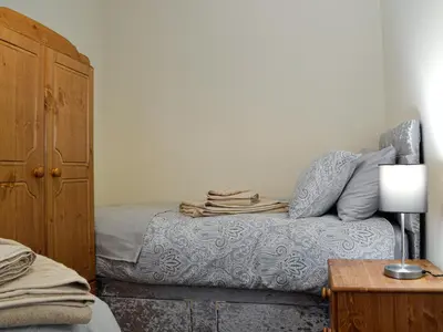 a bedroom with a bed and a dresser at Trefechan in Pumpsaint
