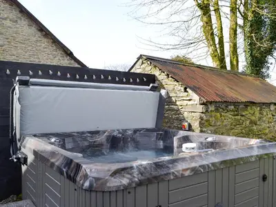 a large hot tub in front of a building at Trefechan in Pumpsaint