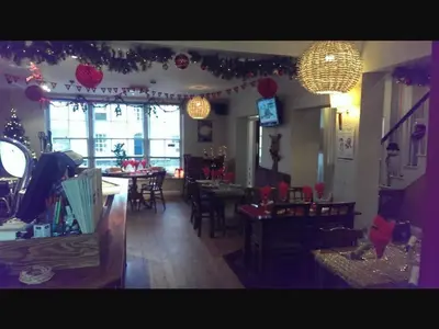 a dining room with christmas lights and tables and chairs at The Old Bell in Shrewsbury