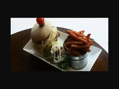 a plate with a sandwich and some onion rings at The Old Bell in Shrewsbury