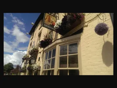 a building with potted plants on the side of it at The Old Bell in Shrewsbury
