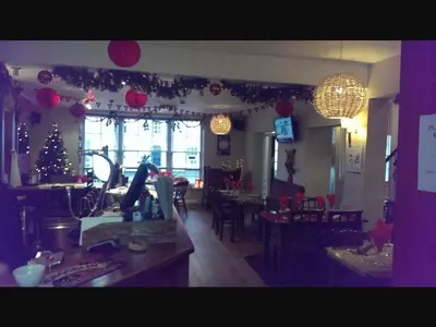 a living room with christmas decorations and a christmas tree at The Old Bell in Shrewsbury