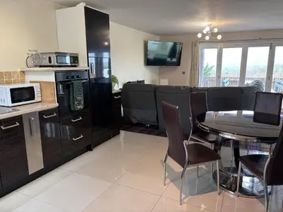 a kitchen and dining room with a table and chairs at Cambrian View in Aberystwyth