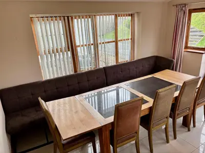 a living room with a table and a couch at Brynhyfryd in Aberystwyth