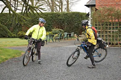 two people on bikes and a police officer at The Old Vicarage Dolfor in Newtown