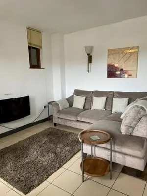 a living room with a couch and a table at The Hay Suite in Aberystwyth