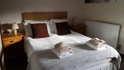 a bedroom with a bed with towels on it at The Wheatsheaf Inn in Ludlow
