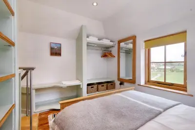 a bedroom with a bed and a window at The Folly in Hereford