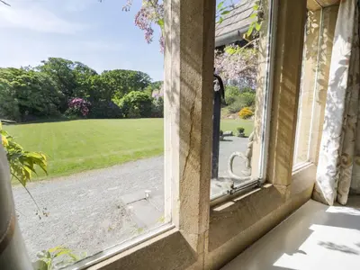 an open window with a view of a yard at Plas Gwynfryn in Llanbedr