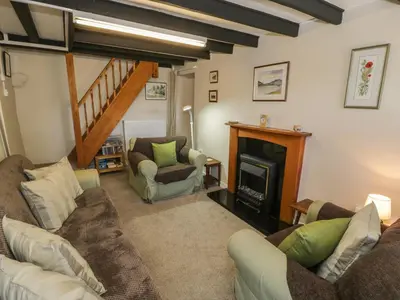 a living room with a couch and a fireplace at Ty Uchaf in Dyffryn
