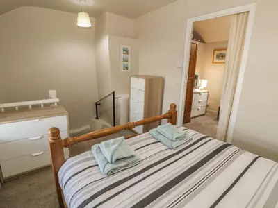 a bedroom with a bed with blue towels on it at Ty Uchaf in Dyffryn