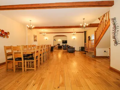 a dining room and living room with a table and chairs at The Mill House in Shrewsbury