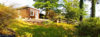 a small cabin in the middle of a field at Sea Moss Cabin in Tywyn