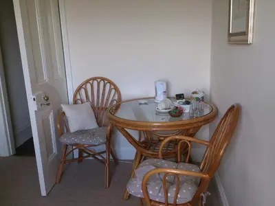 a small table with chairs and a tea kettle on it at Upper Letton Farm in Leintwardine
