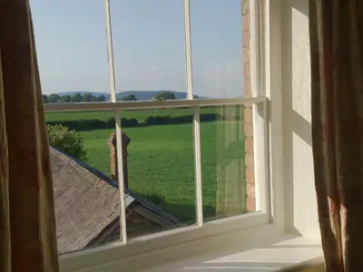 an open window with a view of a green field at Upper Letton Farm in Leintwardine