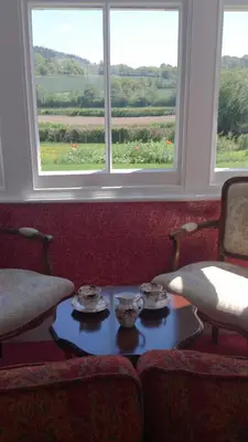 a room with a table and two chairs and a window at Upper Letton Farm in Leintwardine