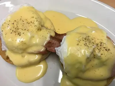 a white plate with eggs and bacon on a plate at Oceandrive in Barmouth