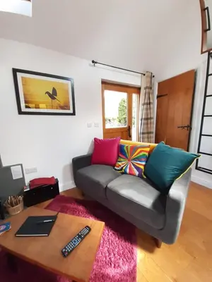a living room with a couch and a table at Little Smithy in Shrewsbury