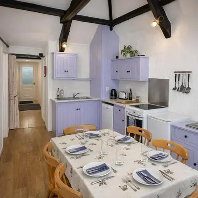 a kitchen with a table with plates and glasses on it at Abergwynant Farm Glamping & Apartments in Dolgellau