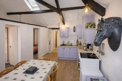a kitchen with a table with a horse head on the wall at Abergwynant Farm Glamping & Apartments in Dolgellau