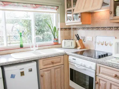 a kitchen with a sink and a window at Ensdon Lea Cottage in Shrewsbury