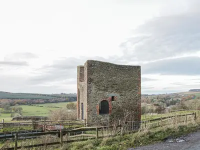 an old stone building on the side of a road at Cranberry Cottage in Shrewsbury