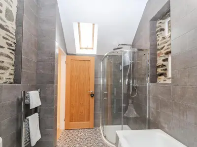 a bathroom with a shower and a sink at Cut Moch, Plas Moelfre Hall Barns in Oswestry
