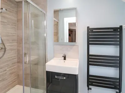 a bathroom with a sink and a glass shower at Dewi Villa in Aberaeron