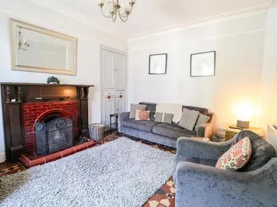 a living room with a couch and a fireplace at Dewi Villa in Aberaeron