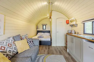 a living room with a couch and a bed at Stiperstones Pod in Shrewsbury